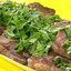 Стейк на ребре с сыром, оливками и травами